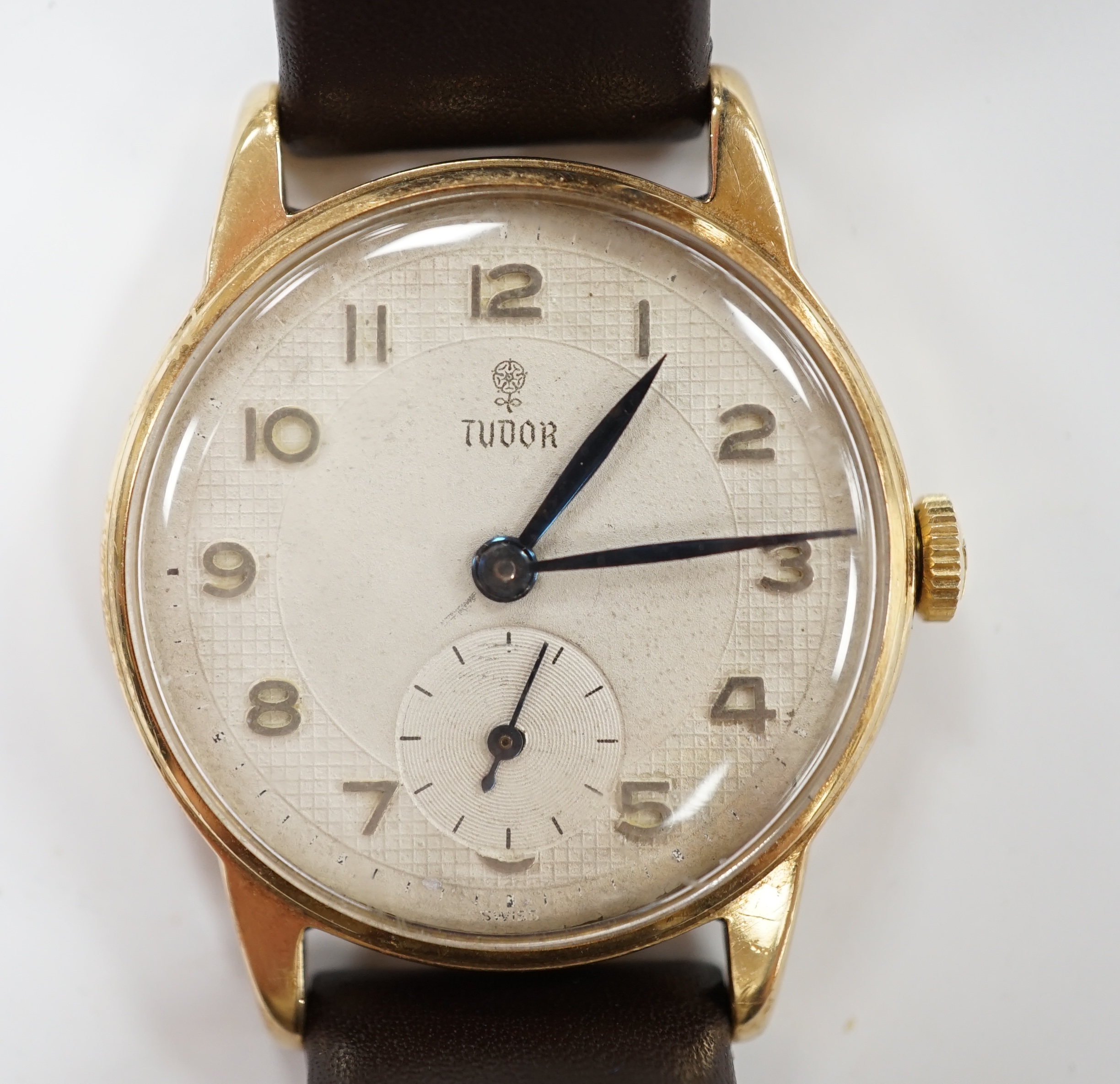 A gentleman's 9ct gold Tudor manual wind wrist watch, with Arabic dial and subsidiary seconds, on later associated strap, case diameter 31mm.
